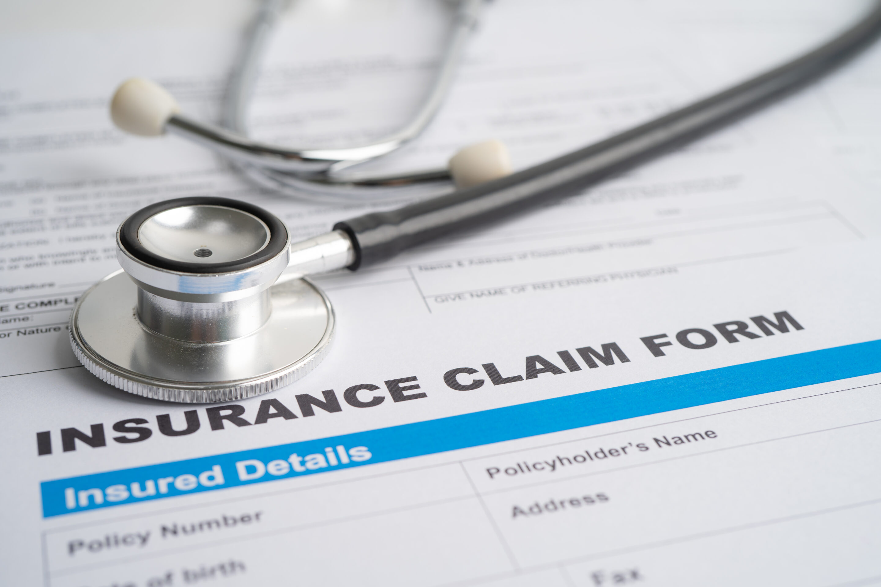 Stethoscope on Insurance claim accident car form Car loan ins