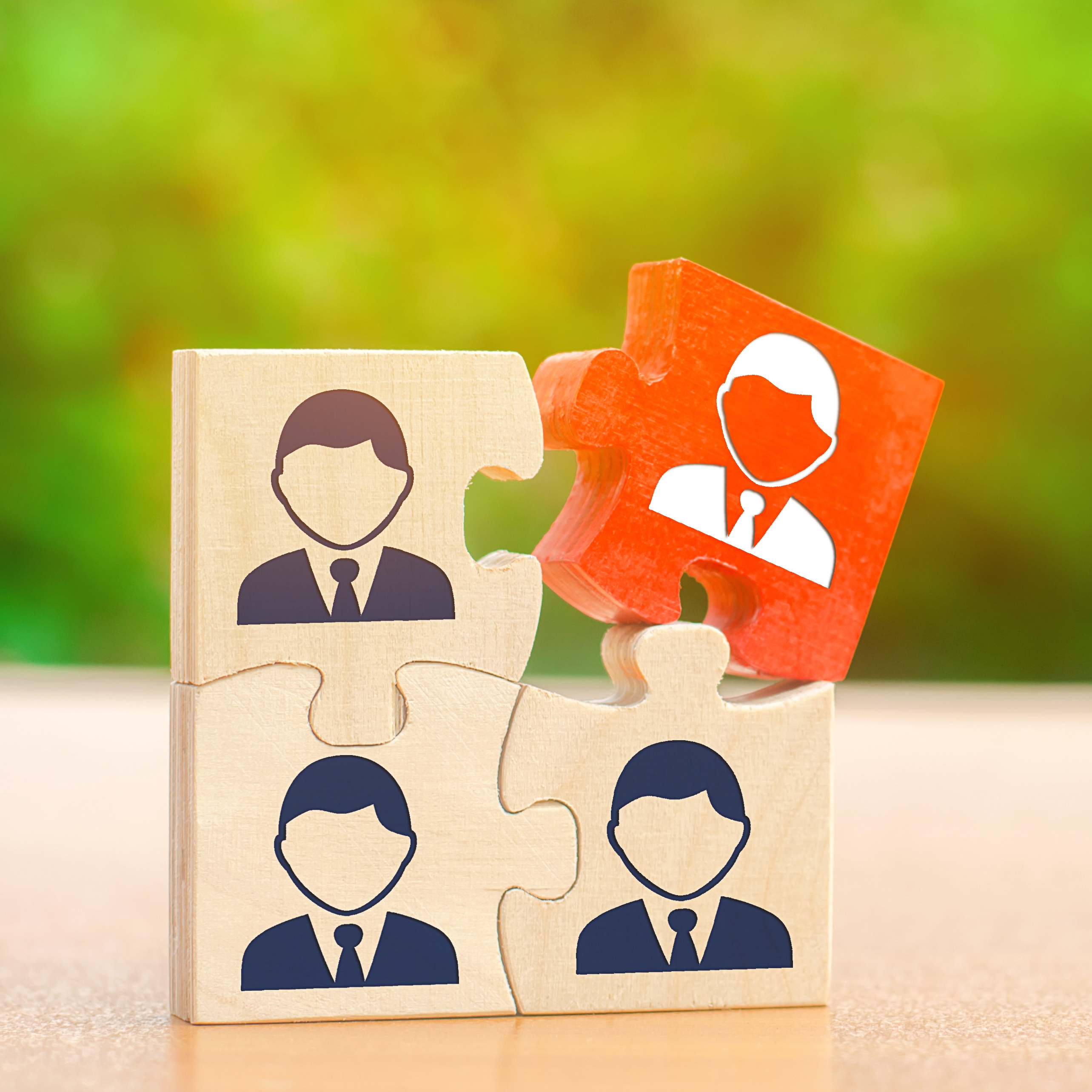Wooden puzzles with the image of workers The concept of personnel management in the company Dismissing an employees from a team Demotion Bad worker Staff cuts Human resources Hiring hire